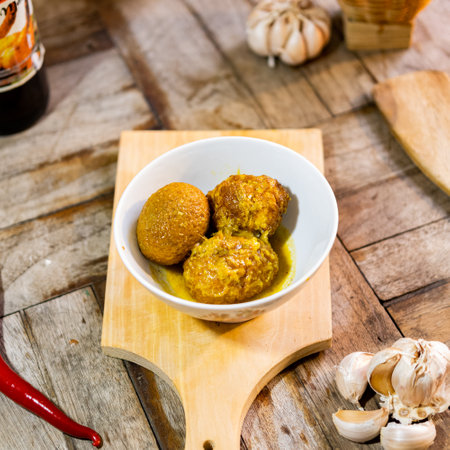 traditional food from indonesia on wooden cutting board and a garlic and chilli with wooden background texture captured on high quality camera.の写真素材