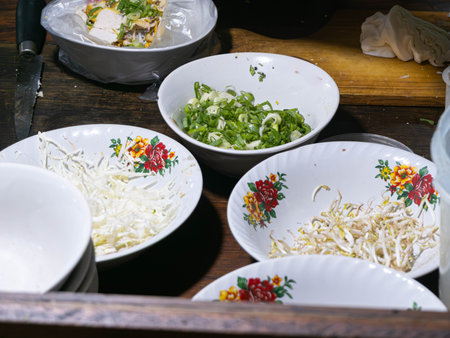 Close up of plates with salad on wooden table.