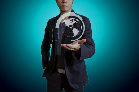 Globe in hand man isolated blue backgroundの写真素材