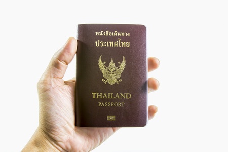 Thailand passport in hand isolated on a white backgroundの写真素材