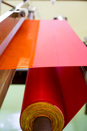 Red silk hand woven on a loomの写真素材