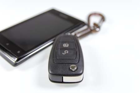 remote control key and mobile phone isolated on white backgroundの写真素材