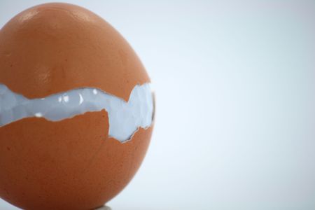 Golf ball and egg on a white backgroundの写真素材