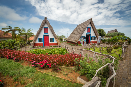 Santana traditional madeira houses with thatched roofs. Old fashioned rural huts - one of them serves as touristic informationの写真素材