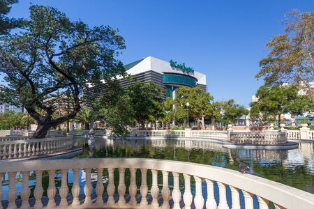 Department store El Corte Ingles, Castellon de la Plana, Spain - 2019.08.10. View at modern commerce center from old, historical Park Ribalta. Small pond sorrouned by stone balustrade and treesのeditorial素材