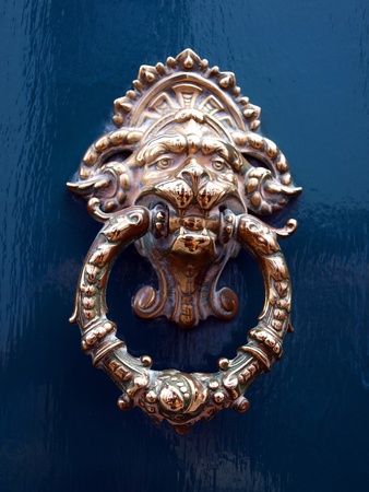 old door knocker as an animal head on a blue backgroundの写真素材