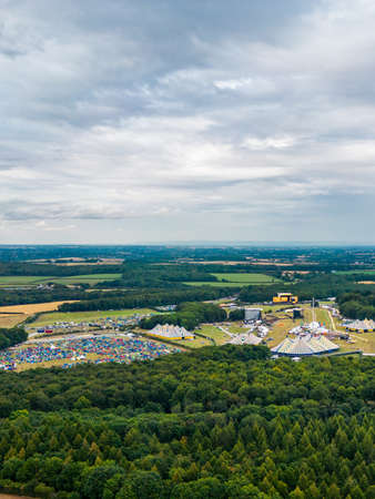 Aerial view over Leeds Festival 2022 which is held in Bramham Park, West Yorkshire. A Music festival with people camping in a park surrounded by woodland.の写真素材