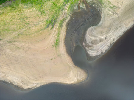 Aerial drone view of Lindley Wood Reservoir, North Yorkshire, showing the dry reservoir basin following heatwave and hot weather.の写真素材