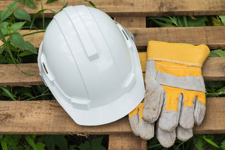white and yellow safety helmet and Protective gloves,