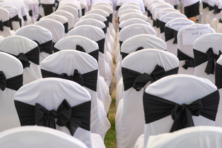 row of white chair and black ribbonの写真素材