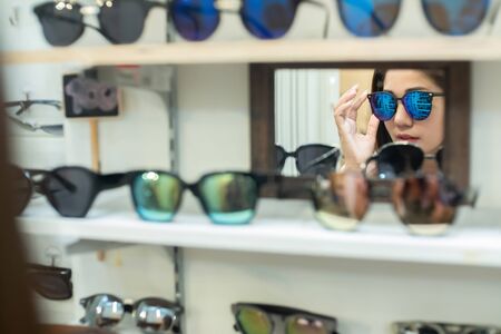 Asian beautiful woman She chooses to buy the right sunglassesの写真素材