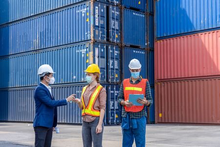 New normal concept,Engineer assistant inspector protect body by wearing mask,helmet and wash hand with alcohol Before entering warehouse or factory Prevent accident from work dust and Coronavirusの写真素材