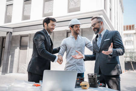 Working in the newnormal, the project engineer and the team leader wear masks. and consulting on the building's solar cell system.engineers team discuss the use of solar for clean energy buildingの写真素材