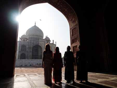 Silhouette morning of indian people at indian palace's window, Taj Mahal.