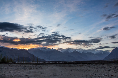 The sun is rising behind the great snow mountain in Nubra Valley, Leh Ladakh.の写真素材