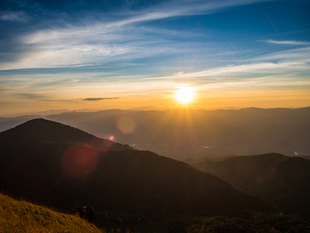 The great flare over the mountain from the sunset with nice blue sky at Mon Jong, Chiangmai, Thailand.の写真素材