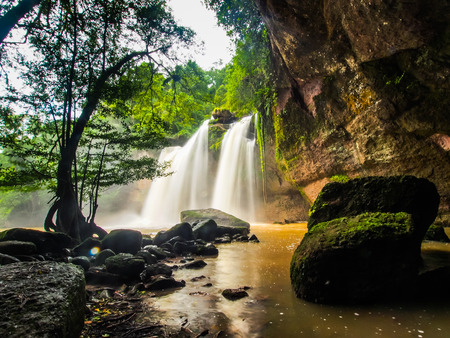 Nice waterfall flows down little hill inside Khao Yai national park of Nakorn Ratchasima. The tropical rain forest with lemongrass on the rocks and green trees give the freshness moment to visitors.の写真素材
