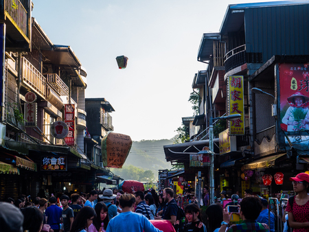 Shifen, Taiwan - Nov 17, 2016 : Moment of tourists walking around the shopping area for souvenir....