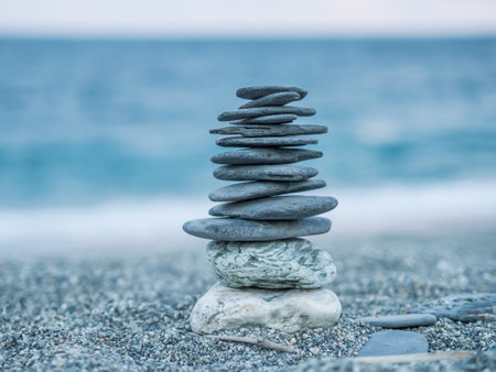 The stacking stones on the beach, representing the believe in Buddhism as in a sign of mediation,...