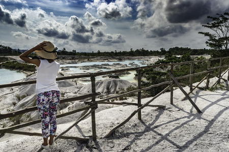 View of a standing woman looking at Danau Kaolin from the island of Belitungの写真素材