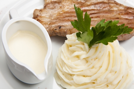 meat with mashed potatoes and the sauce の写真素材