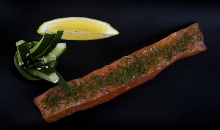 Raw salmon fillet with spices on plate の写真素材