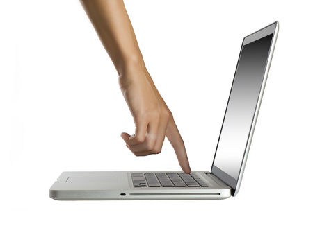 laptop with woman hand isolated on white backgroundの写真素材