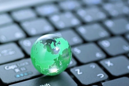 Glass globe over keyboardの写真素材