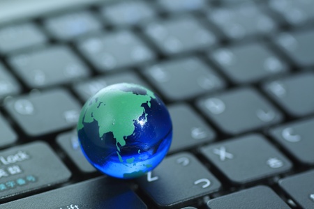 Glass globe over keyboardの写真素材