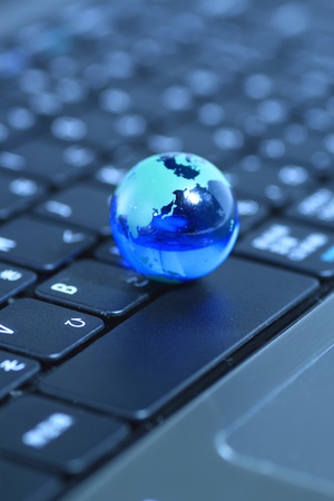 Glass globe over keyboardの写真素材