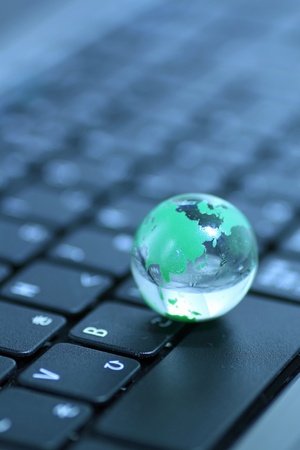 Glass globe over keyboardの写真素材