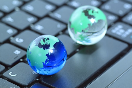 Glass globe over keyboardの写真素材
