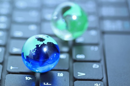Glass globe over keyboardの写真素材