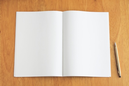 White open notebook and pen on wood background. 