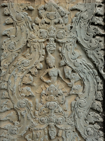Carving (of ancient God) on the wall which made from rockの写真素材