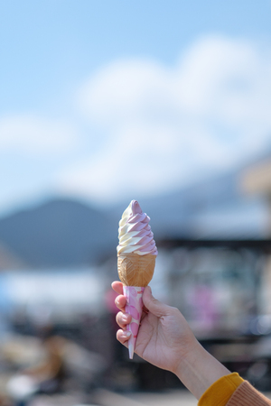 Eating Icecream in cold weather at Fujisanの写真素材