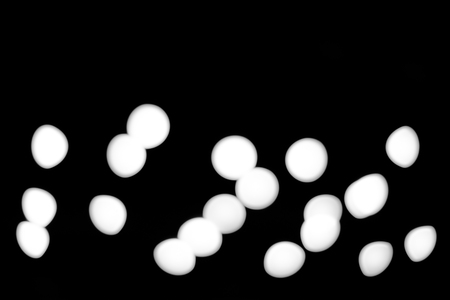 White Bokeh in plain black backgroundの写真素材