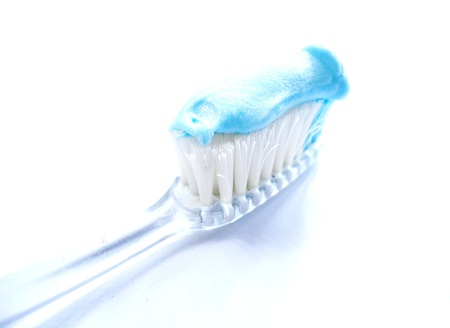 Close up a Colored brush and blue toothpaste On a white backgroundの写真素材