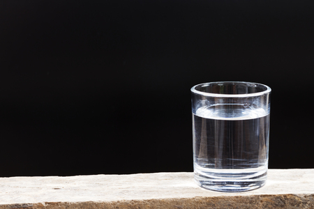 Drinking water on a dark background. Drinking water on a dark background.