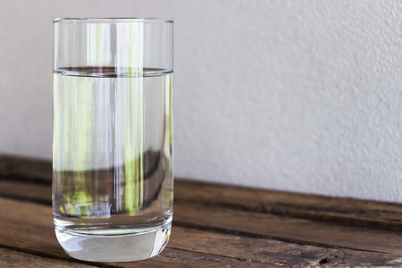 Drinking water in glass on a wooden floor.の写真素材
