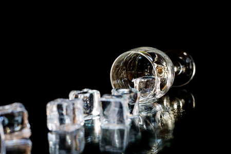 Ice and glass on a dark background.の写真素材
