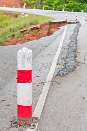 Broken asphalt  Side along the asphalt road collapsed because of erosion  の写真素材