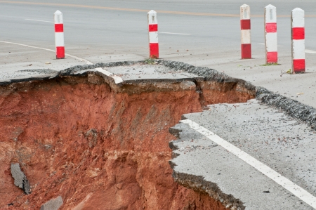 Broken asphalt  Side along the asphalt road collapsed because of erosion  の写真素材