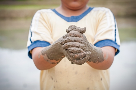 Boy hands with mudの写真素材