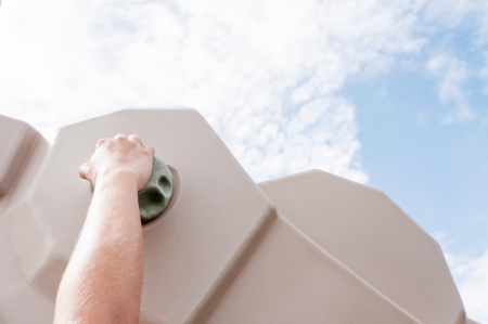 Hand climber clinging tightly to the hook climbing gymの写真素材