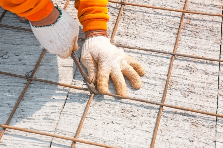 Worker, rebar gridwork across a floor for strengthの写真素材