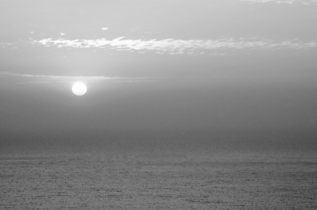 black and white cloudy sunrise (sunset) at seaの写真素材