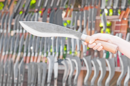 Knife in a hand with knife backgroundの写真素材