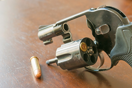Gun and 9mm bullets on table