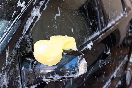 Sponge over the car for washingの写真素材
